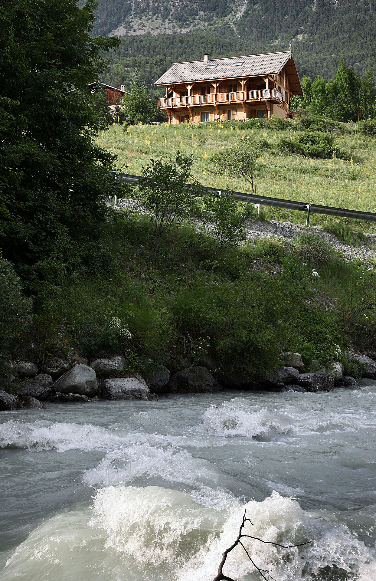Ice water from Alps in flow past chalet
